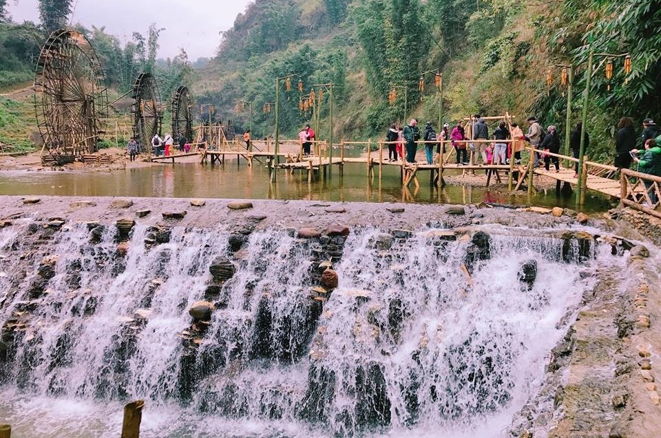 Cat Cat Village Sapa waterfall surrounded by rocks and greenery