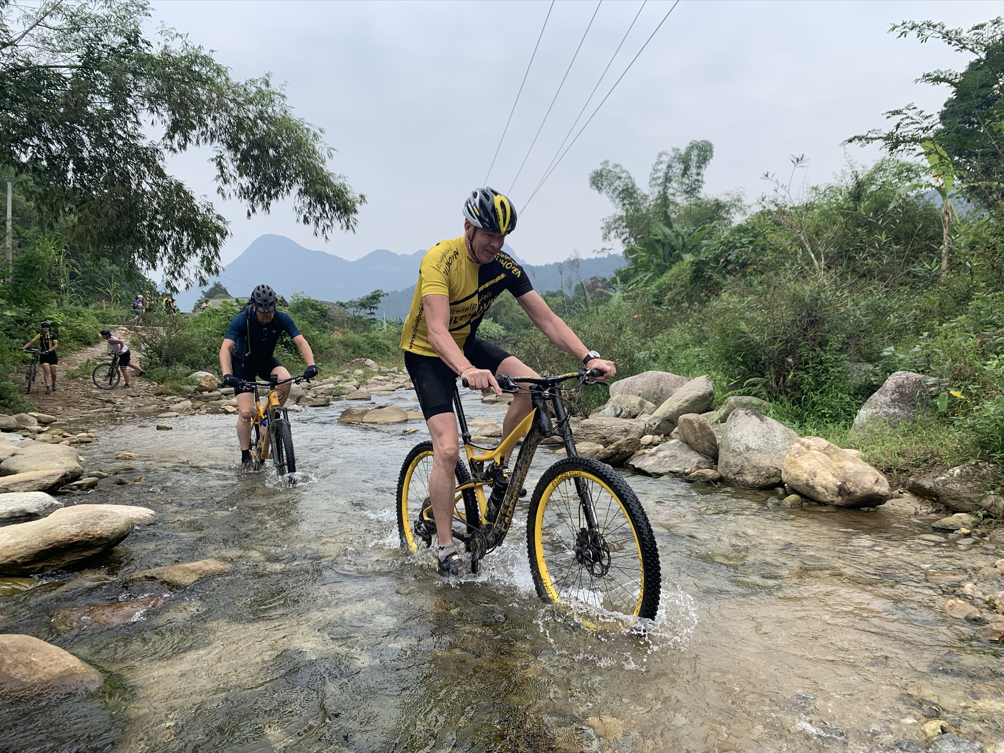 Mountain biking on cliffside trails – exciting things to do in Ha Giang surrounded by panoramic mountain scenery.