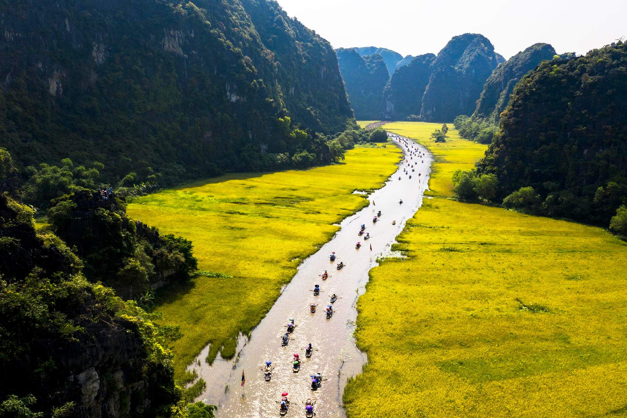 Boat ride through Tam Coc limestone landscapes
