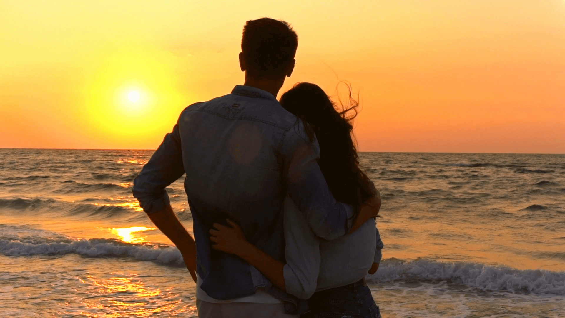Couple walking together through Hoi An Ancient Town at sunset