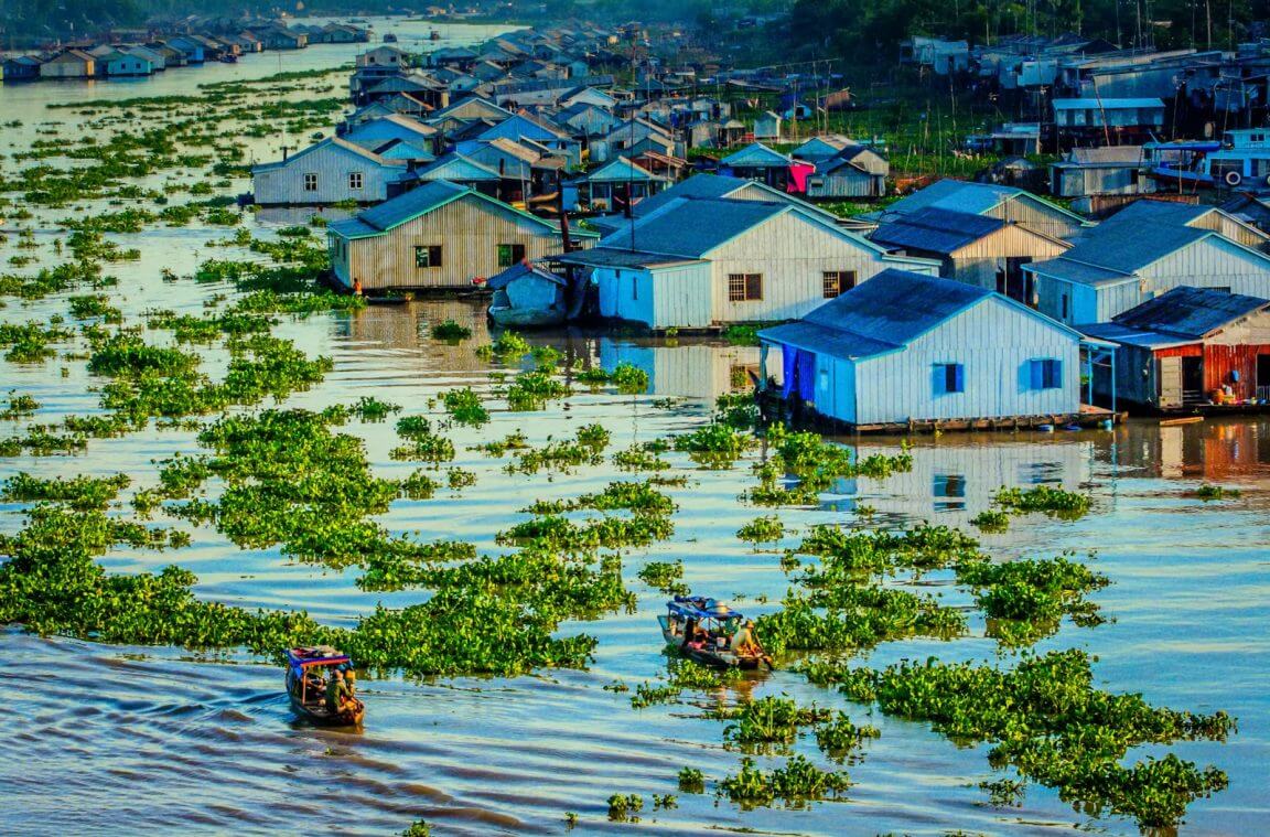 Local life along a river with floating houses in Vietnam