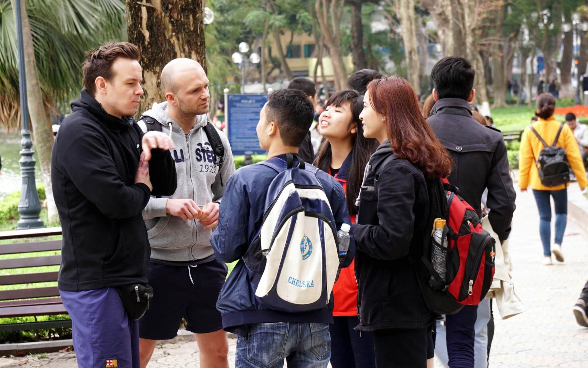 Polite greeting between a foreign visitor and local people showing Vietnam etiquette for foreigners