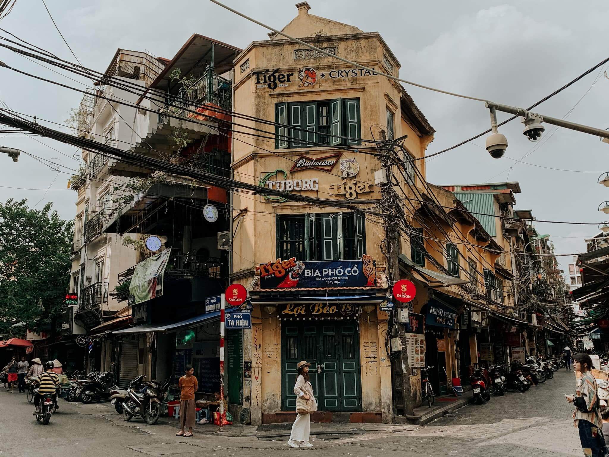 Street life in Hanoi Old Quarter with traditional shops and cafés