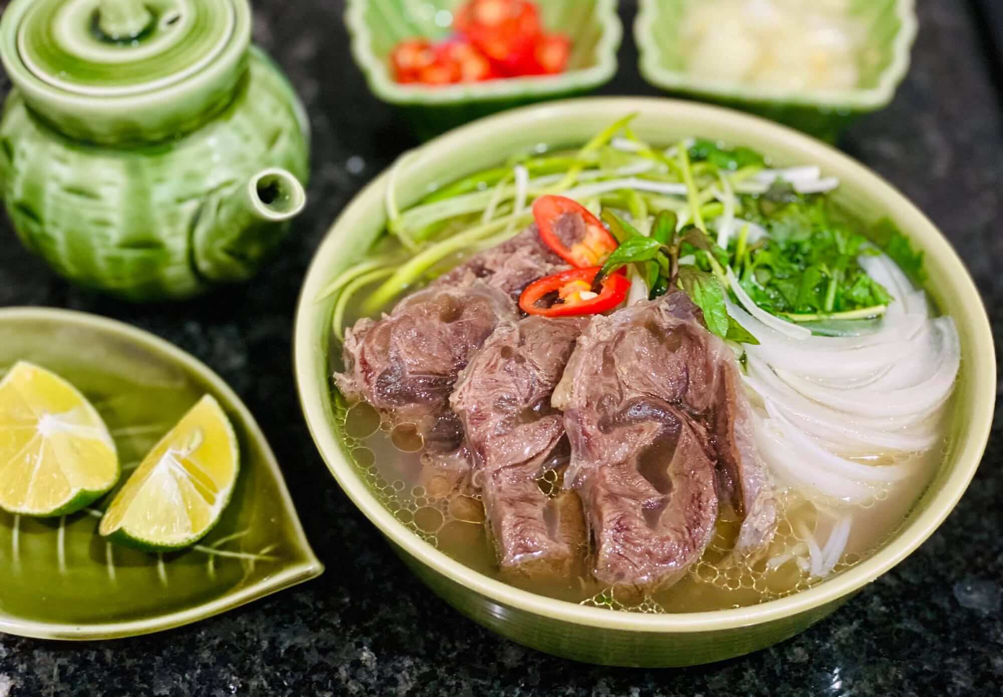 Traditional bowl of pho served with fresh herbs