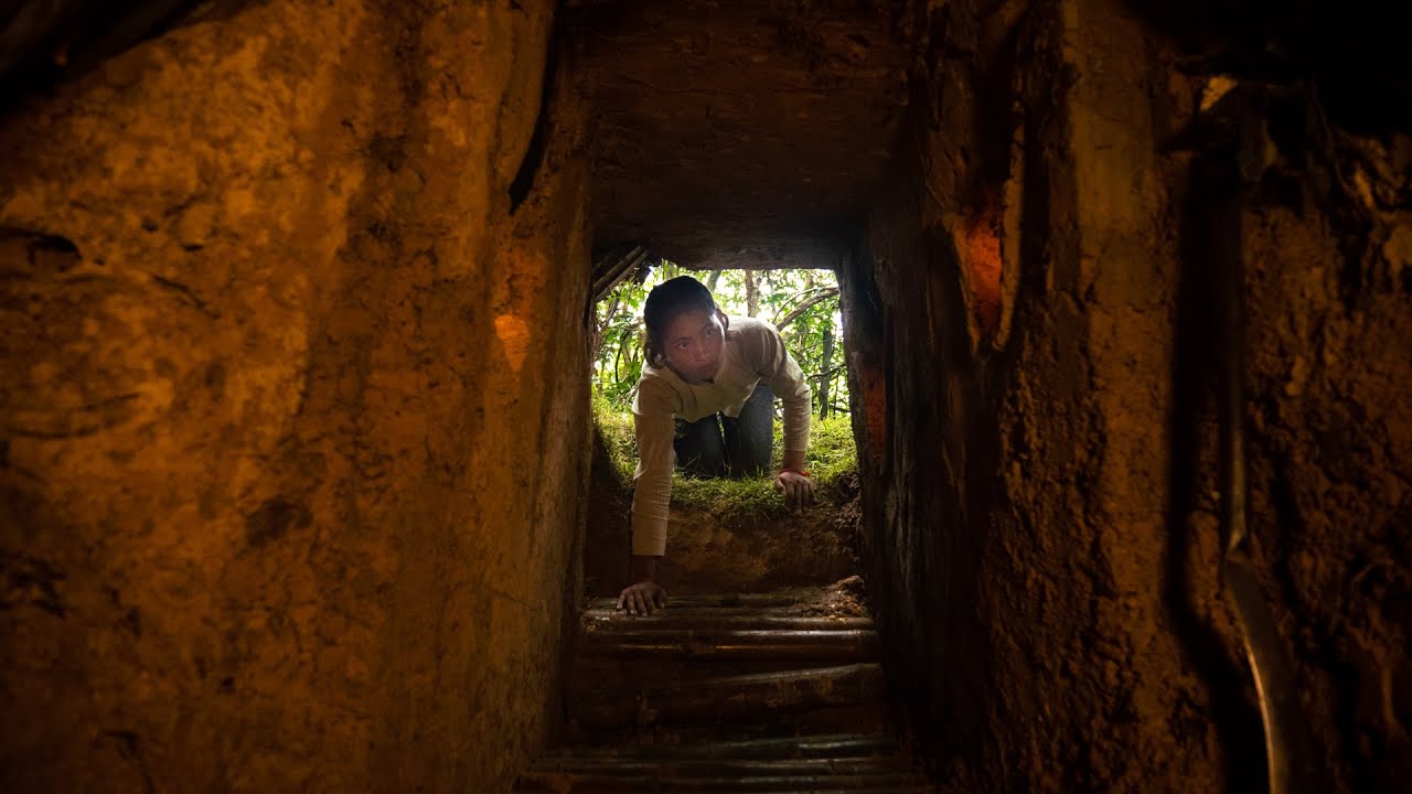 Visitors exploring underground sections of the Cu Chi Tunel