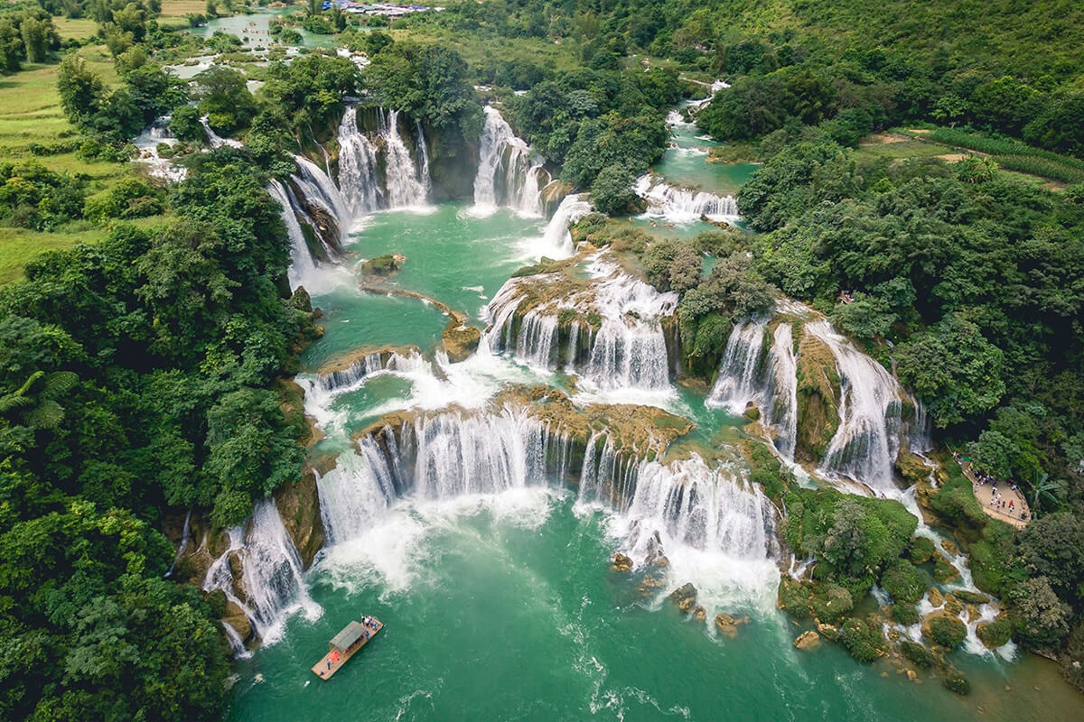 Ban Gioc Waterfall cascading beside limestone mountains in Cao Bang, Vietnam.