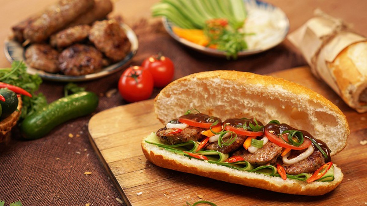 Crispy baguette filled with pickles and grilled pork