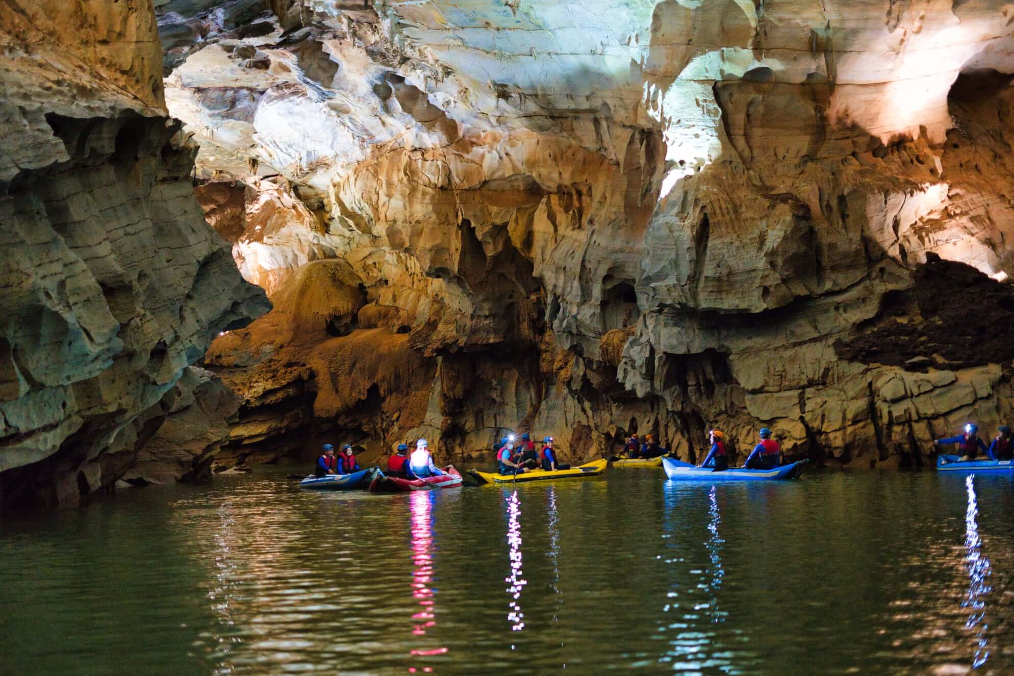Boat entering Phong Nha Cave inside Phong Nha–Ke Bang National Park, Vietnam.