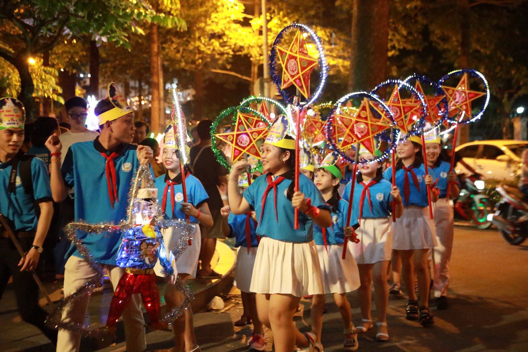 Children carrying colorful lanterns at night
