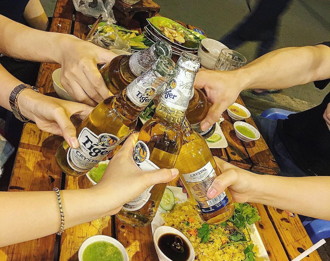 Friends clinking glasses during a lively dinner