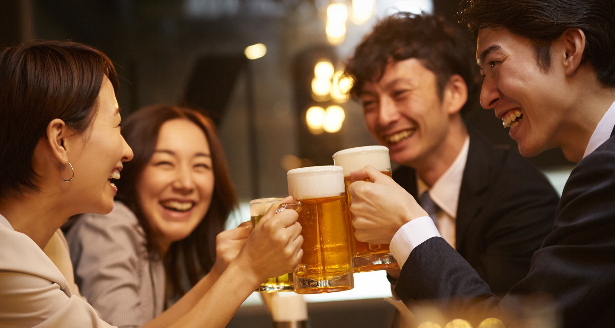 Group cheering together before taking a sip