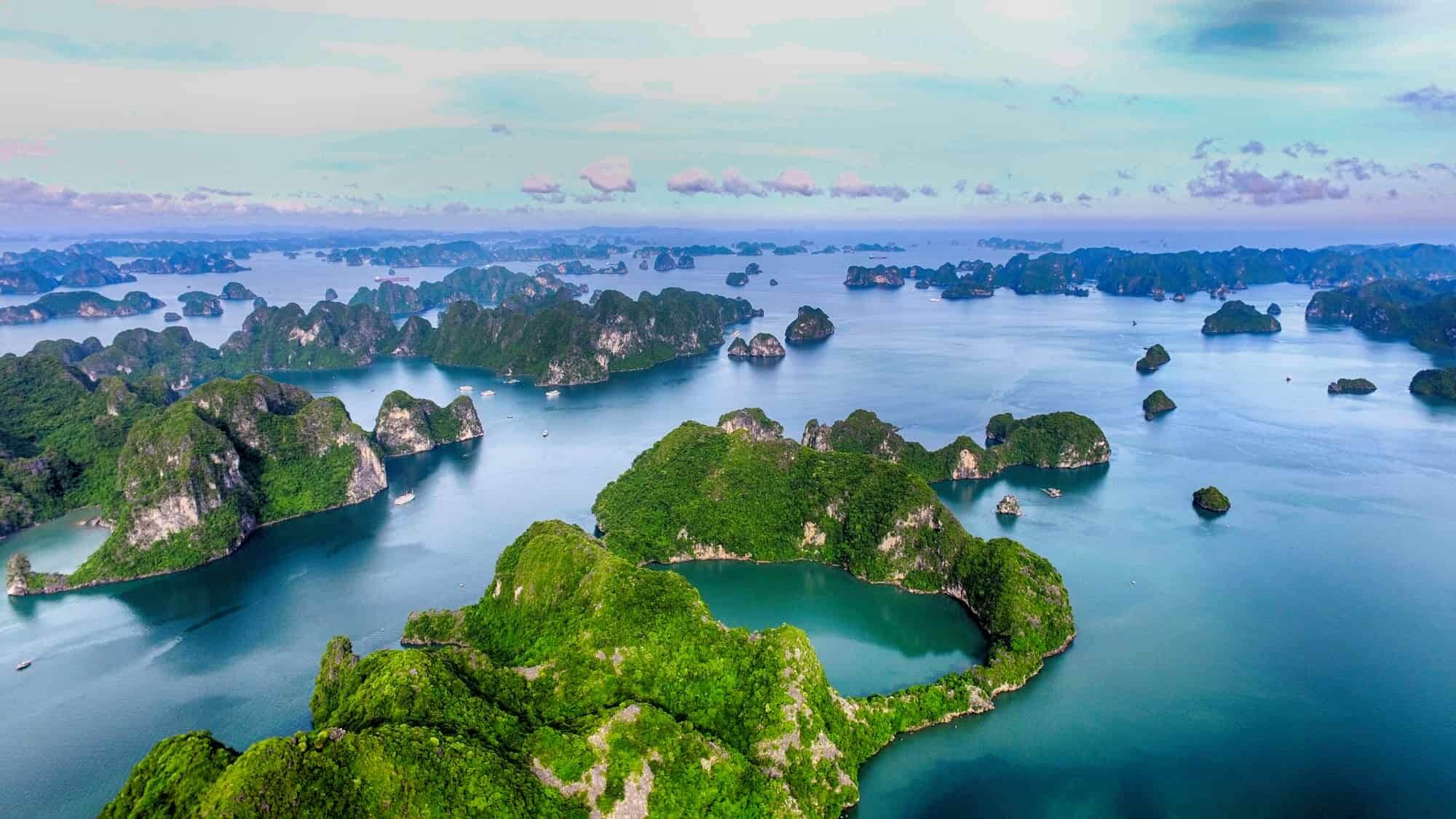 Limestone karsts rising from emerald waters in Ha Long Bay, Vietnam.