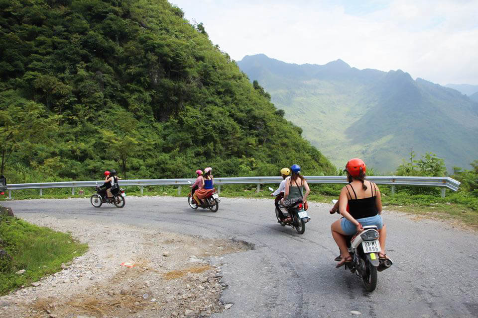 Motorbike riders exploring the Ha Giang Loop mountain roads