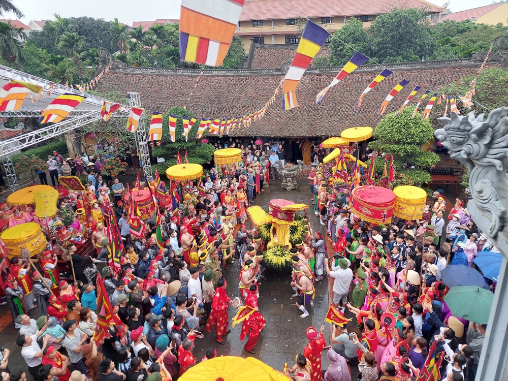 Participants carrying umbrellas during a rainy festival