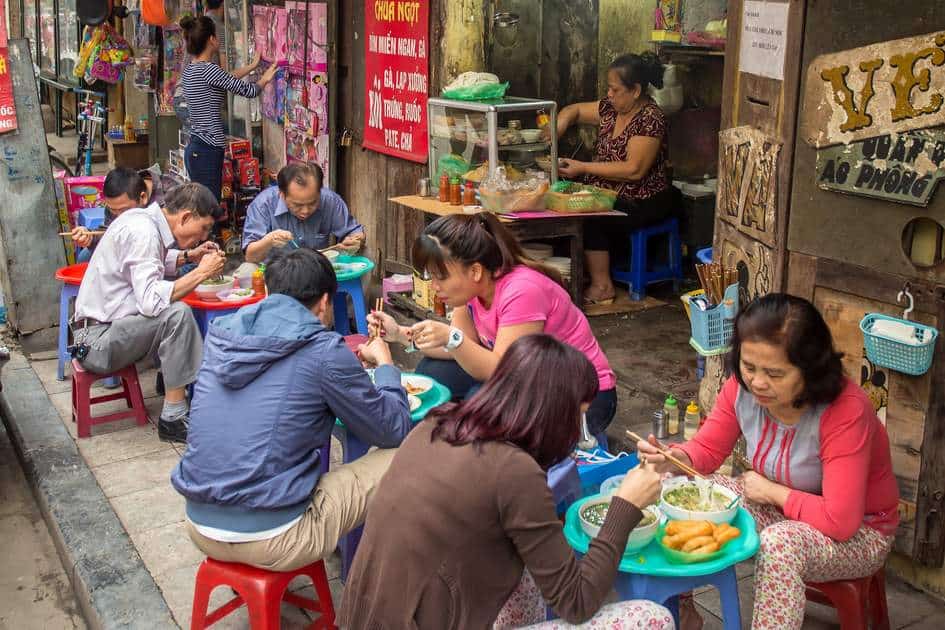 Traveler enjoying authentic local cuisine in Vietnam