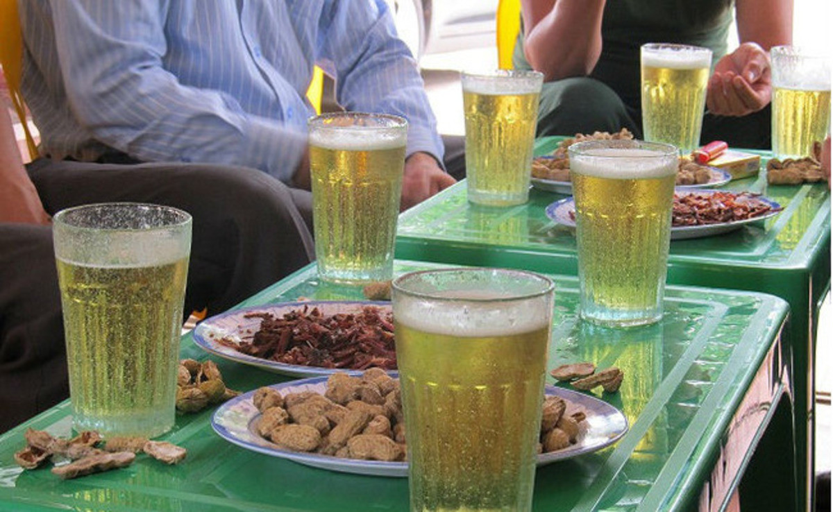Vietnamese friends raising glasses during a casual evening gathering