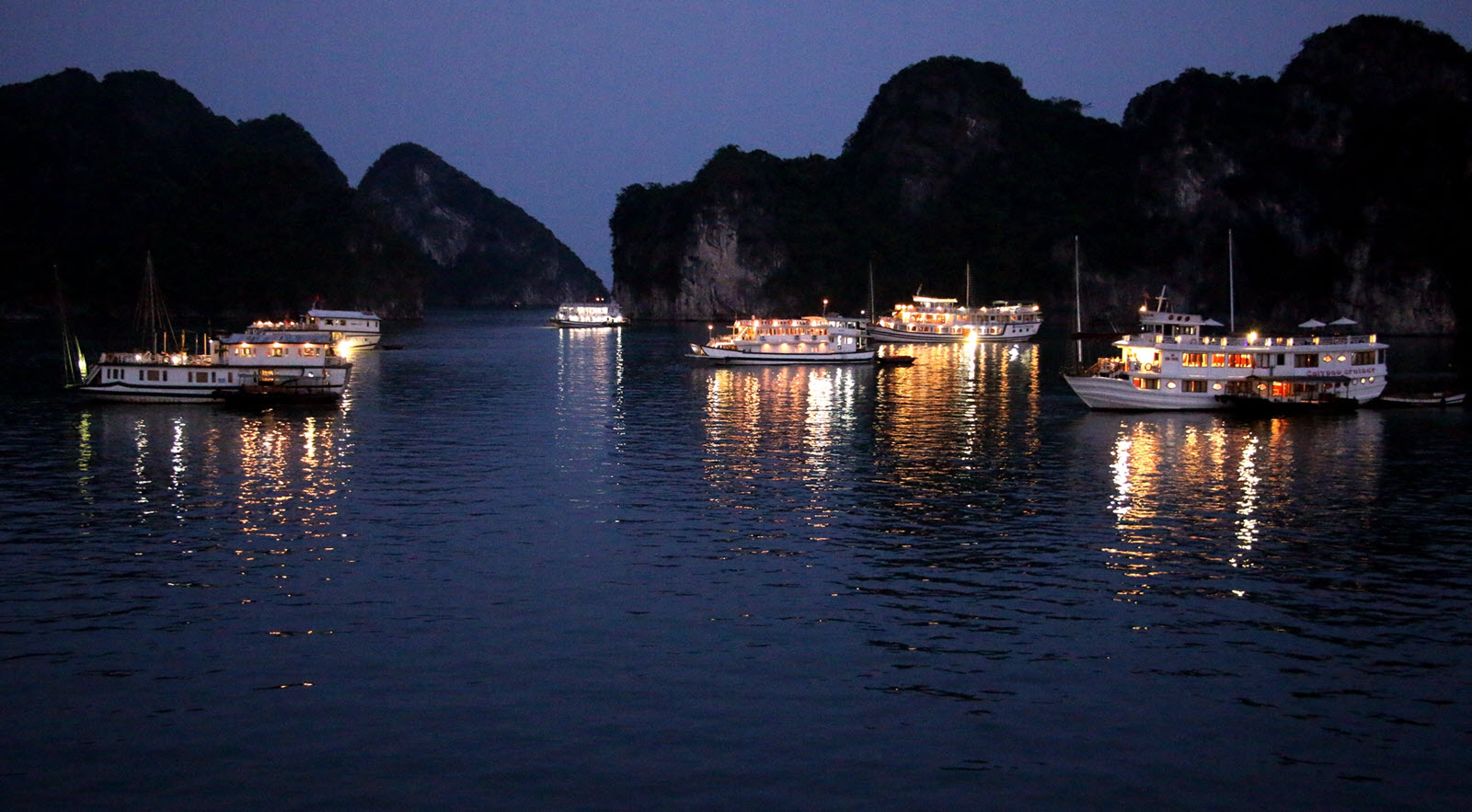 Overnight cruise ship anchored in Ha Long Bay at sunset