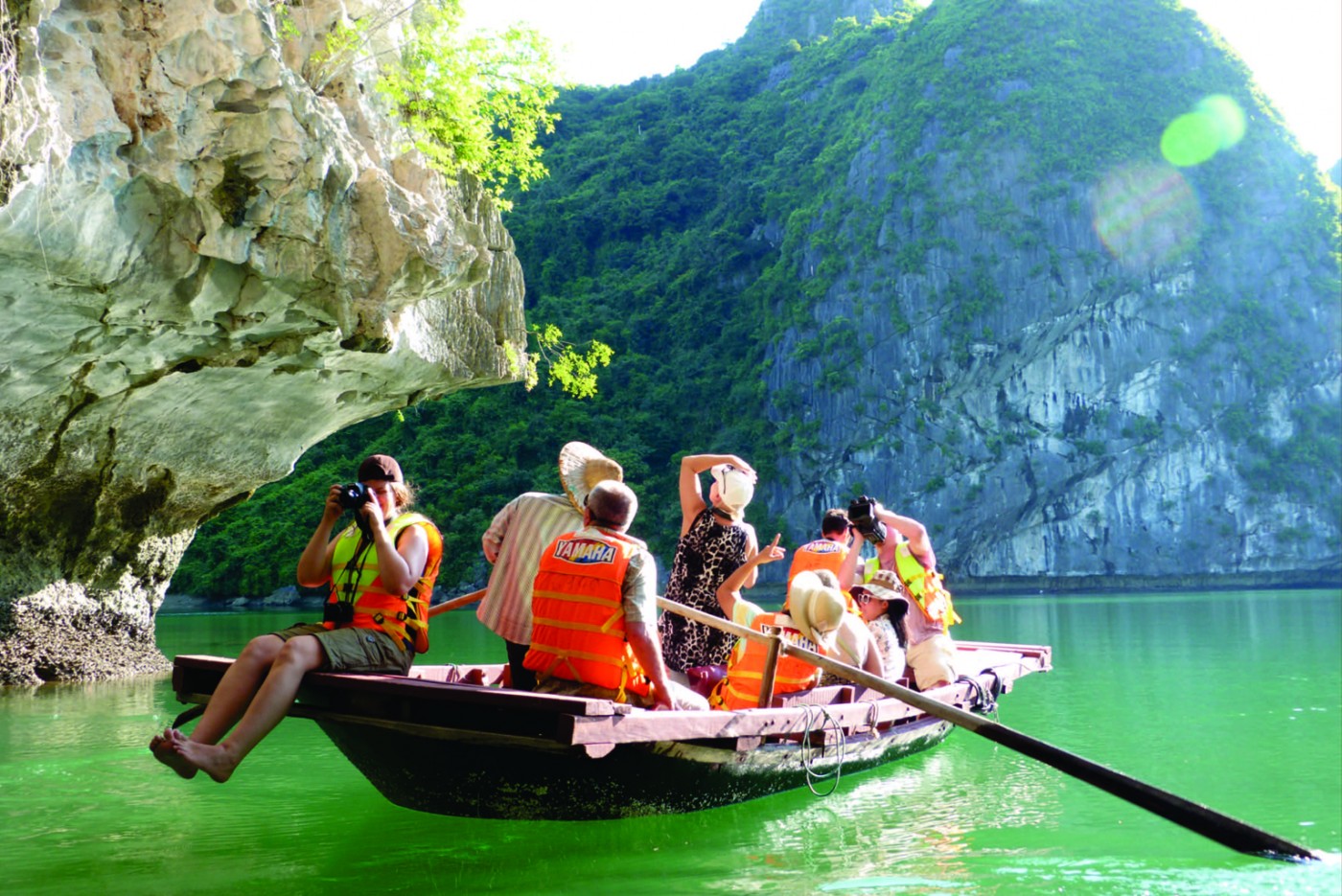 Tourists exploring caves and taking photos during a Ha Long Bay trip
