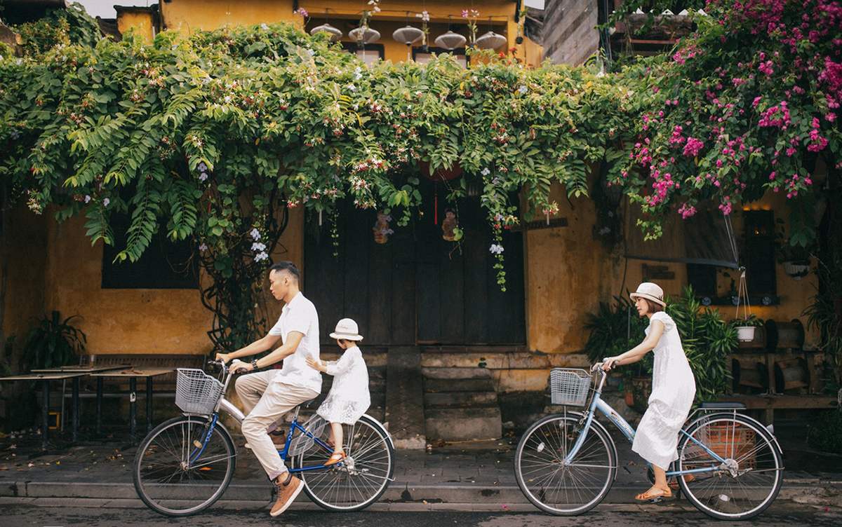 Travelers cycling through quiet streets and rice fields around Hoi An