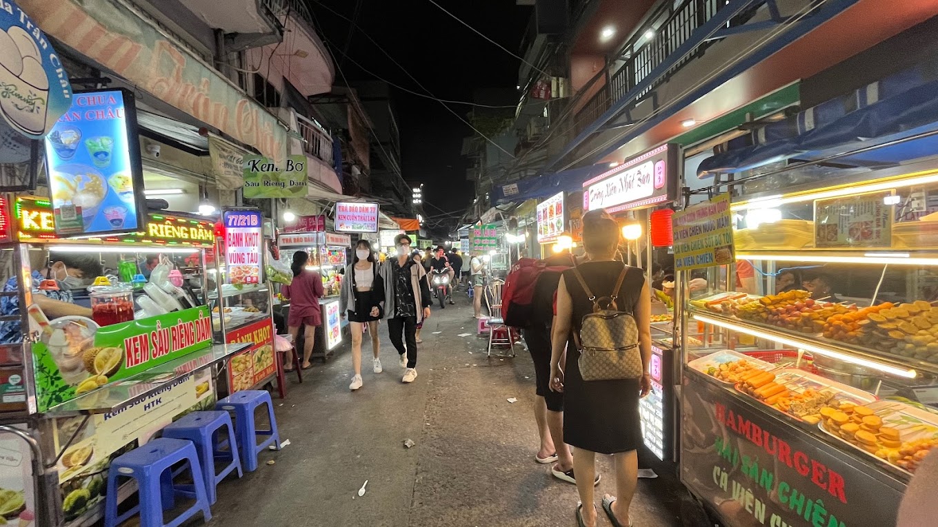 Vietnamese street food stalls with local dishes and vibrant atmosphere
