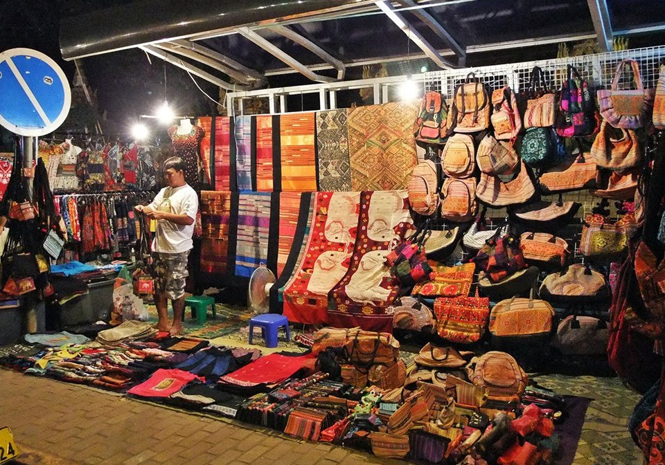 Handwoven textiles and crafts at a local night market in Laos