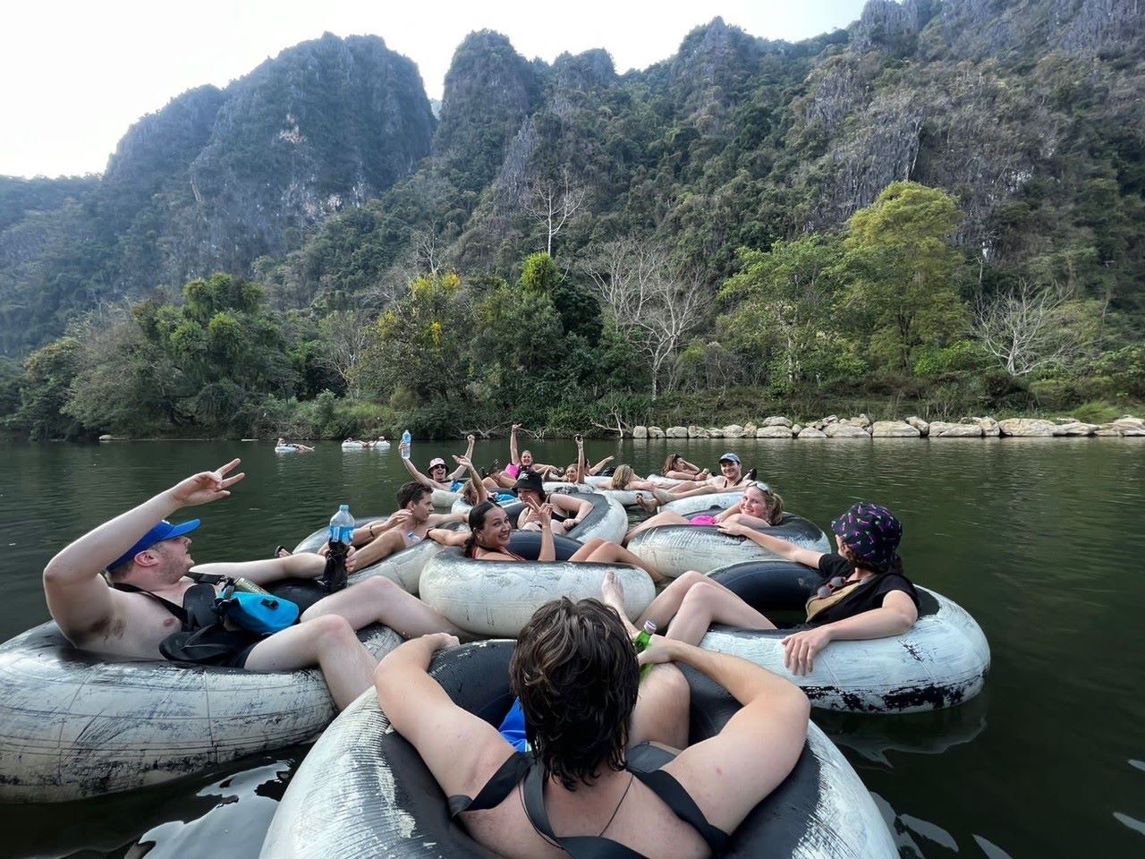 Kayaking adventure on river with limestone mountains in background