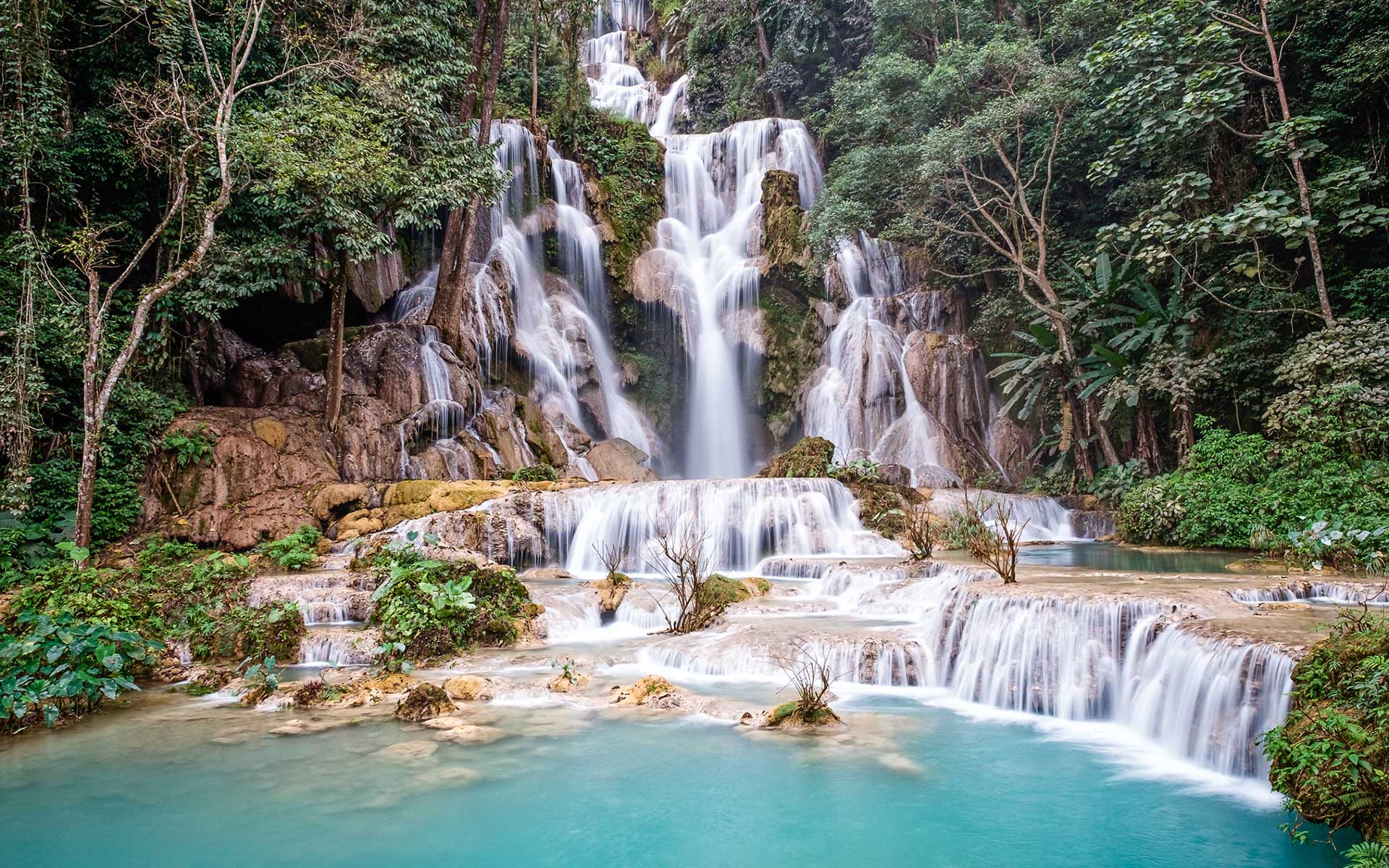 Lush green landscape and waterfalls in Luang Prabang during rainy season