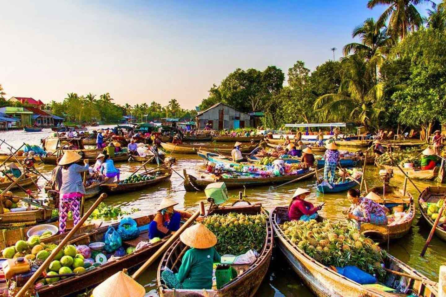 Peaceful river landscape with boats and palm trees in southern Vietnam