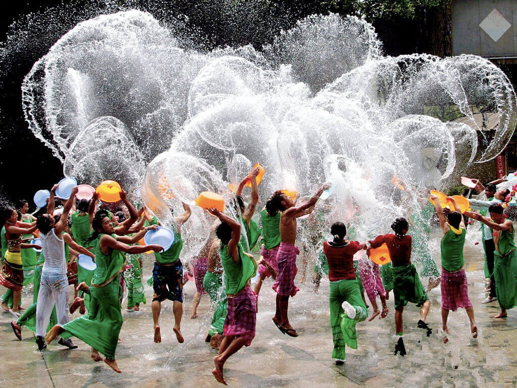 People celebrating Khmer New Year festival with traditional water activities