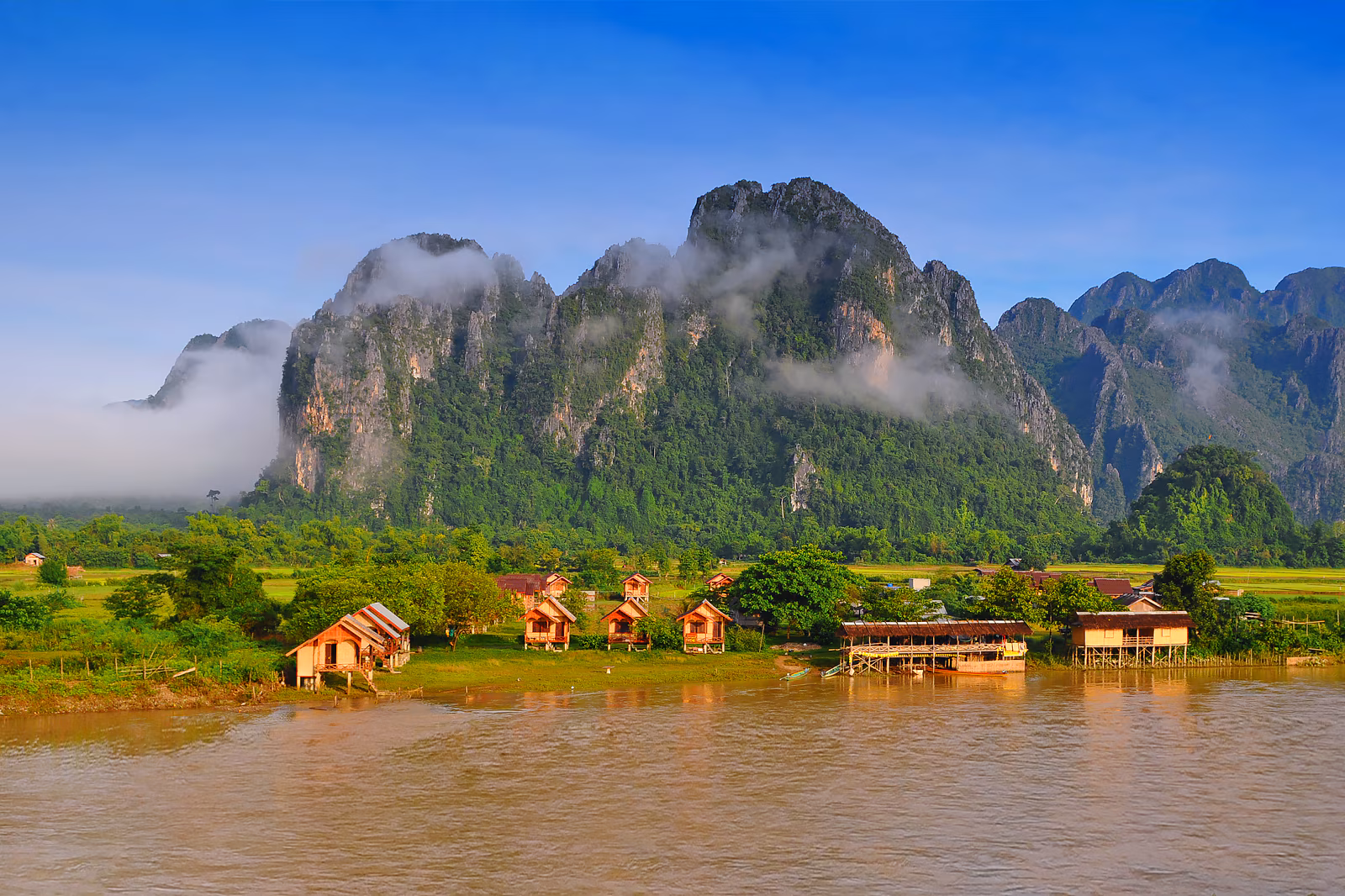 Scenic landscape of Laos with mountains, river, and traditional temples