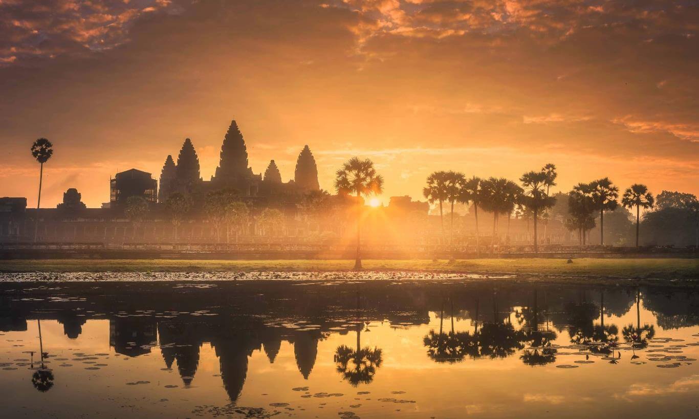 Sunrise view of Angkor Wat temple reflected in a lotus pond
