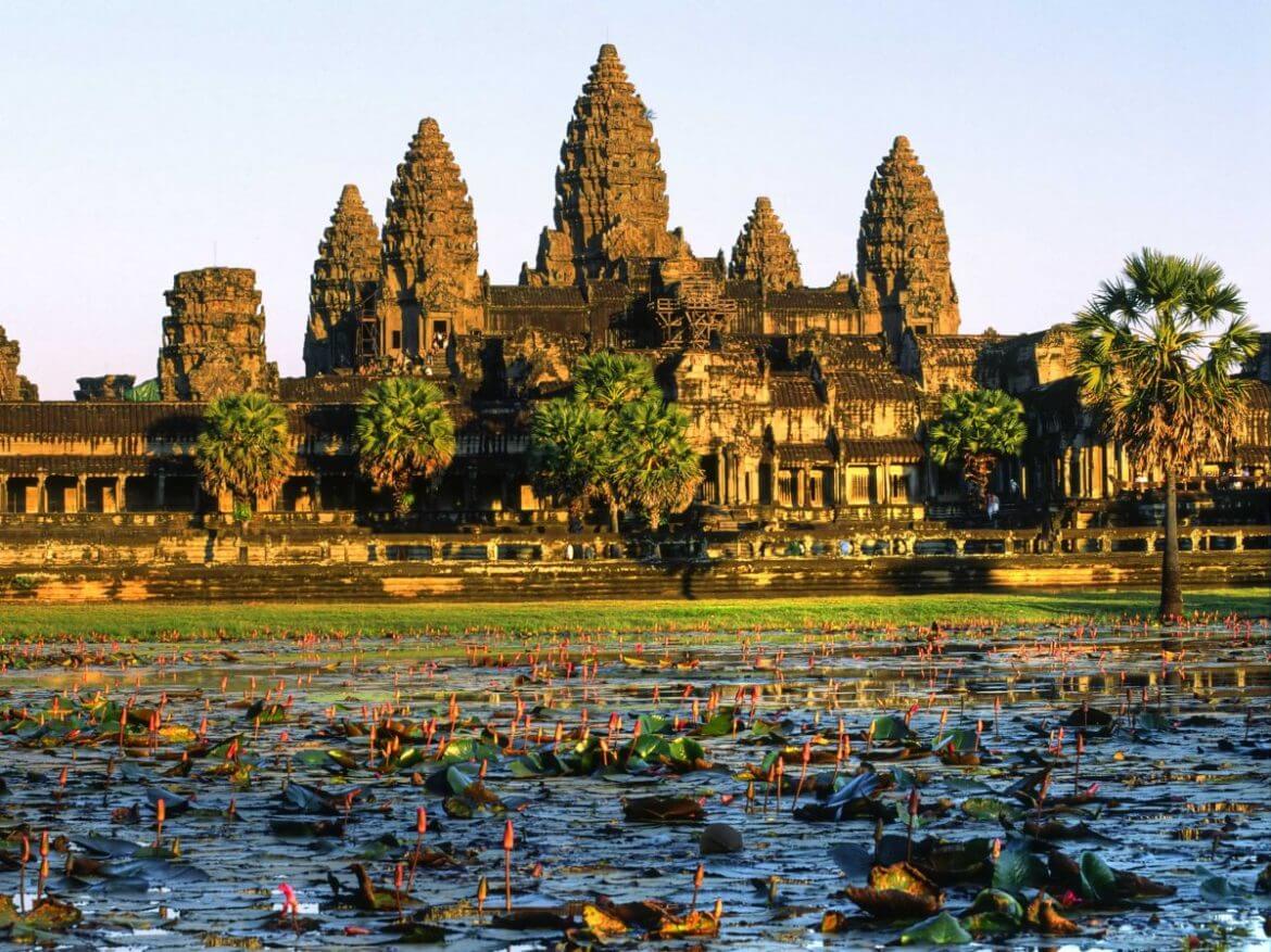 Sunrise view of Angkor Wat temple reflecting on a lotus pond in Siem Reap