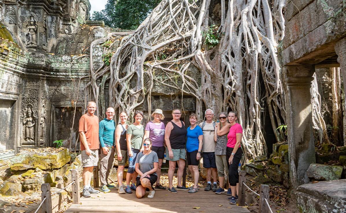 Travelers exploring Angkor temples with a local tour guide