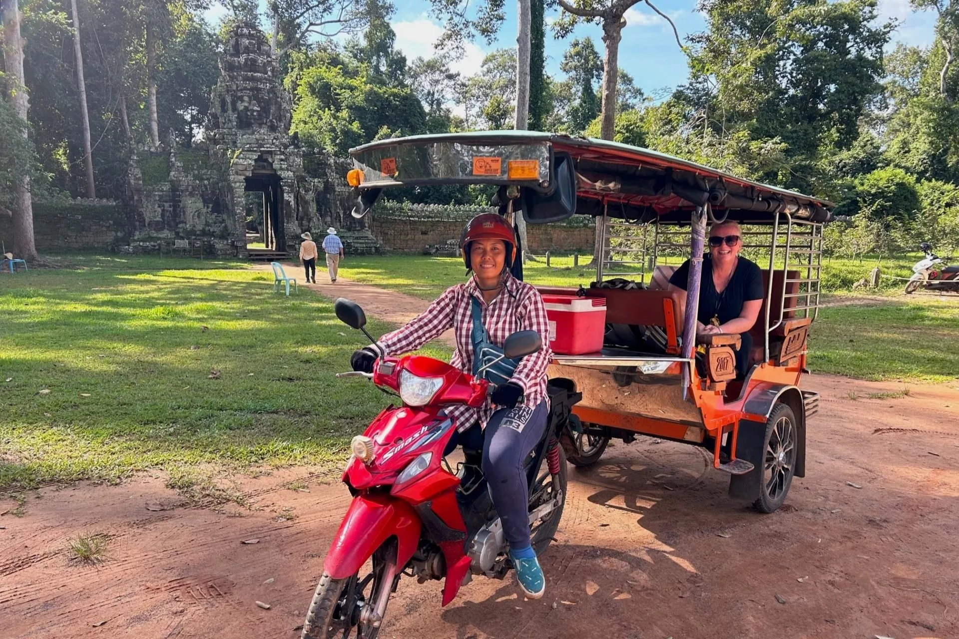 Travelers exploring Laos with local transportation and maps