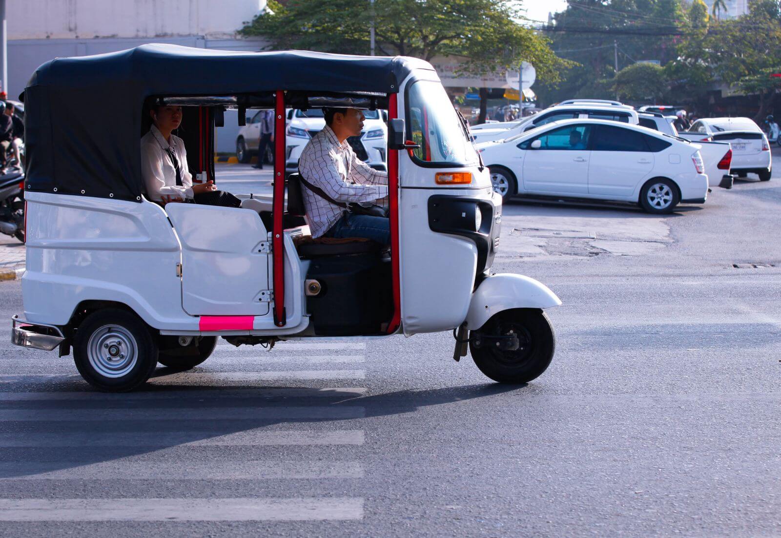 Tuk tuk transportation on a busy street in Phnom Penh