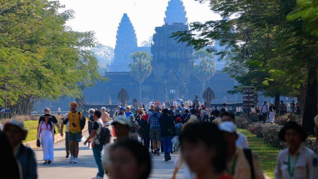 Visitors exploring the Angkor Wat temple complex in Siem Reap Cambodia