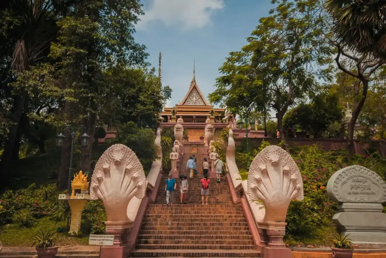 Wat Phnom temple on a hill surrounded by greenery in Phnom Penh